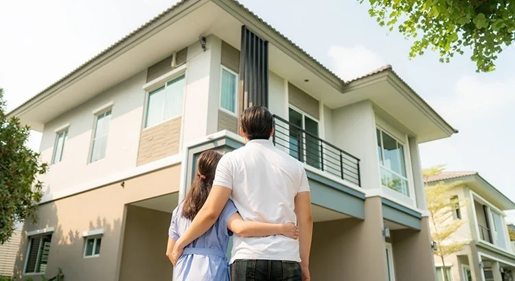 young couple looking up at a condo