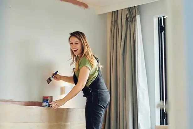 woman painting her living room walls
