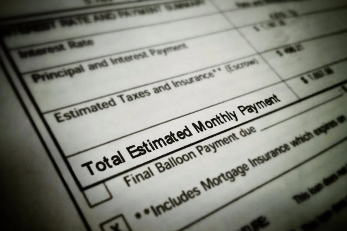 closure of paperwork for a mortgage showing estimated monthly payment