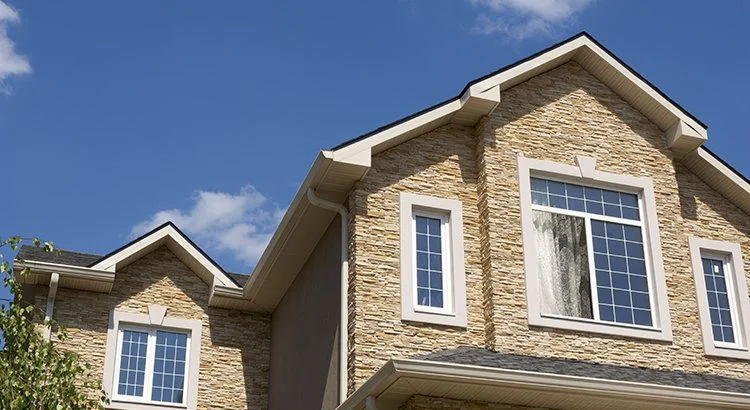 exterior of house with large windows looking upwards