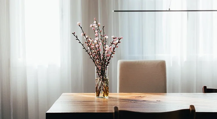 dining room table with a vase and flowers