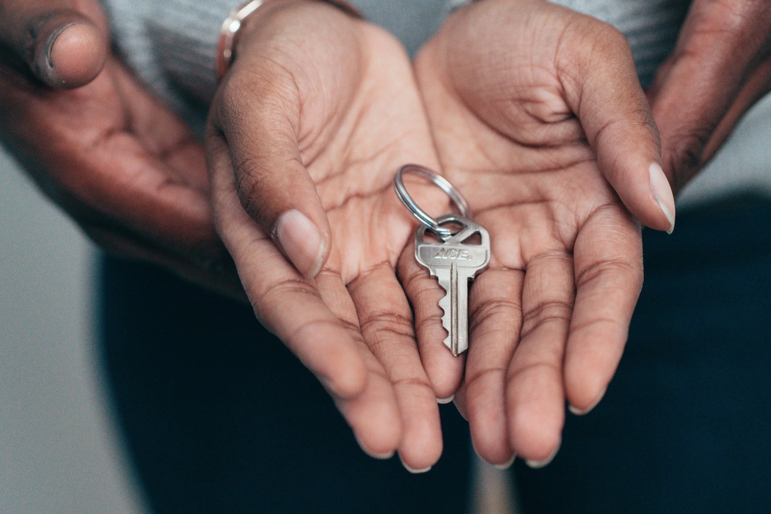 hands holding a key