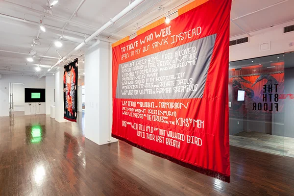 Left: Tony Cokes, Evil.12. (edit.b): Fear, Spectra & Fake Emotions , 2009. Right: Chto Delat, Tortures (I Want To Add . . .) , 2019, and Migrants (To Those Who) , 2019. Installation view. Image courtesy the artists. Photo: Julia Gillard.