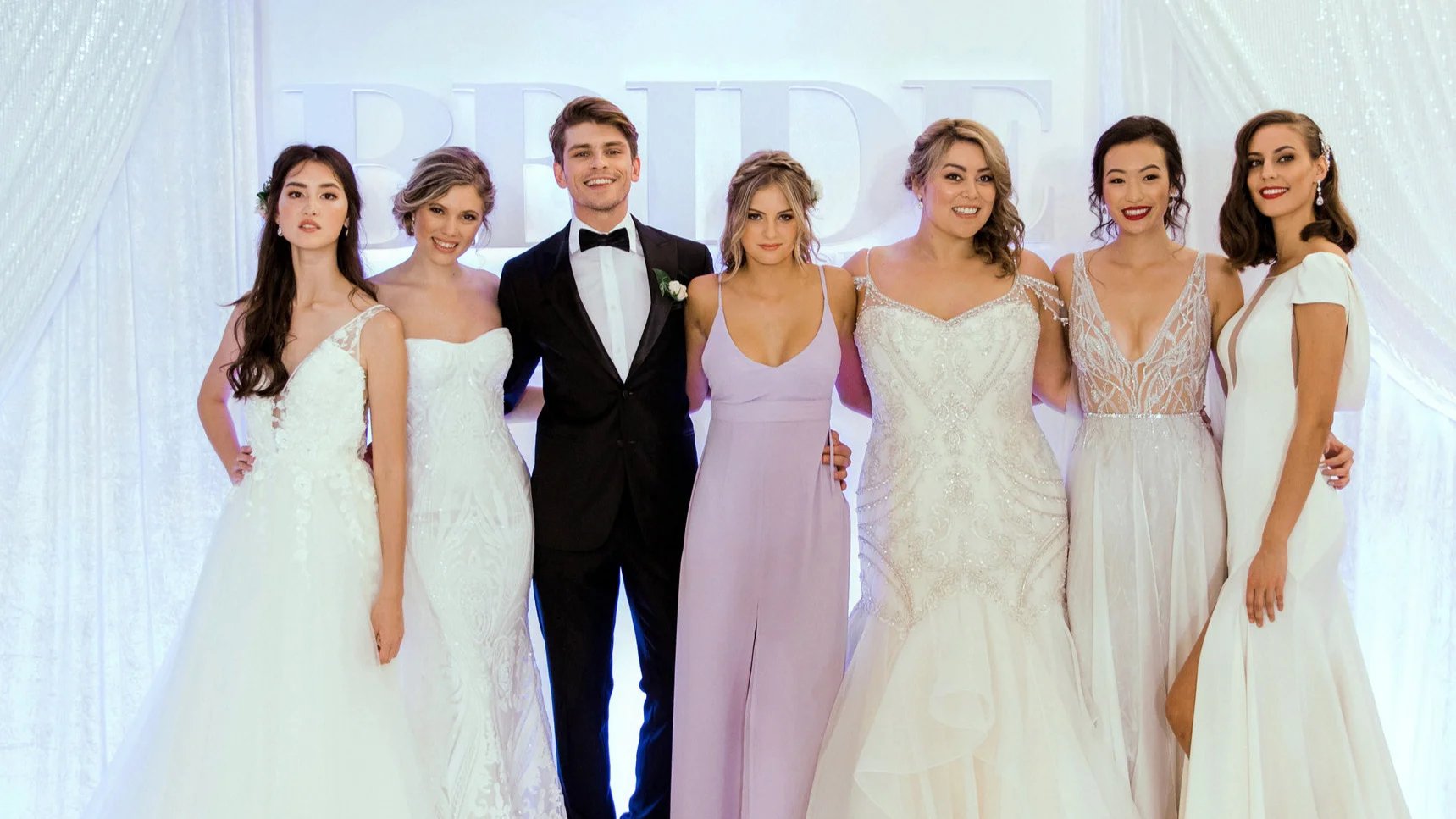 Bride & Groom Magazine Fashion Show ©Bride & Groom Wedding Show 2019 photos by © Bride & Groom Magazine , ©S weet Events Photography and © SheltonPictures DESIGNERS: Astra Bridal , Vinka Design , Jessica Bridal , Jessica Bridal Couture , John Zimmermann Couture , Felicitys Bridal , The Bridal House by Corina Snow , Kellylin Couture , The Stockroom , Dorset Suits , Rembrandt , Devonché , Maggie Sottero , Sottero & Midgley , Theia Couture , Made with Love , Zavana Bridal , Stella York , Martina Liana , Allure Bridals , Marys Bridal , Rebecca Ingram , Luna Novias and Christina Rossi MAKEUP & HAIR: F ACE ME Makeup & Hair NZ // BACKDROP DRAPING: Stylish Weddings & Events // COMPERE: Mike Steffens DJ & MC // FLOWERS: Dianna Marie "think flowers" // SHOES & JEWELLERY: Astra Bridal // Models: Red 11, 62 Models