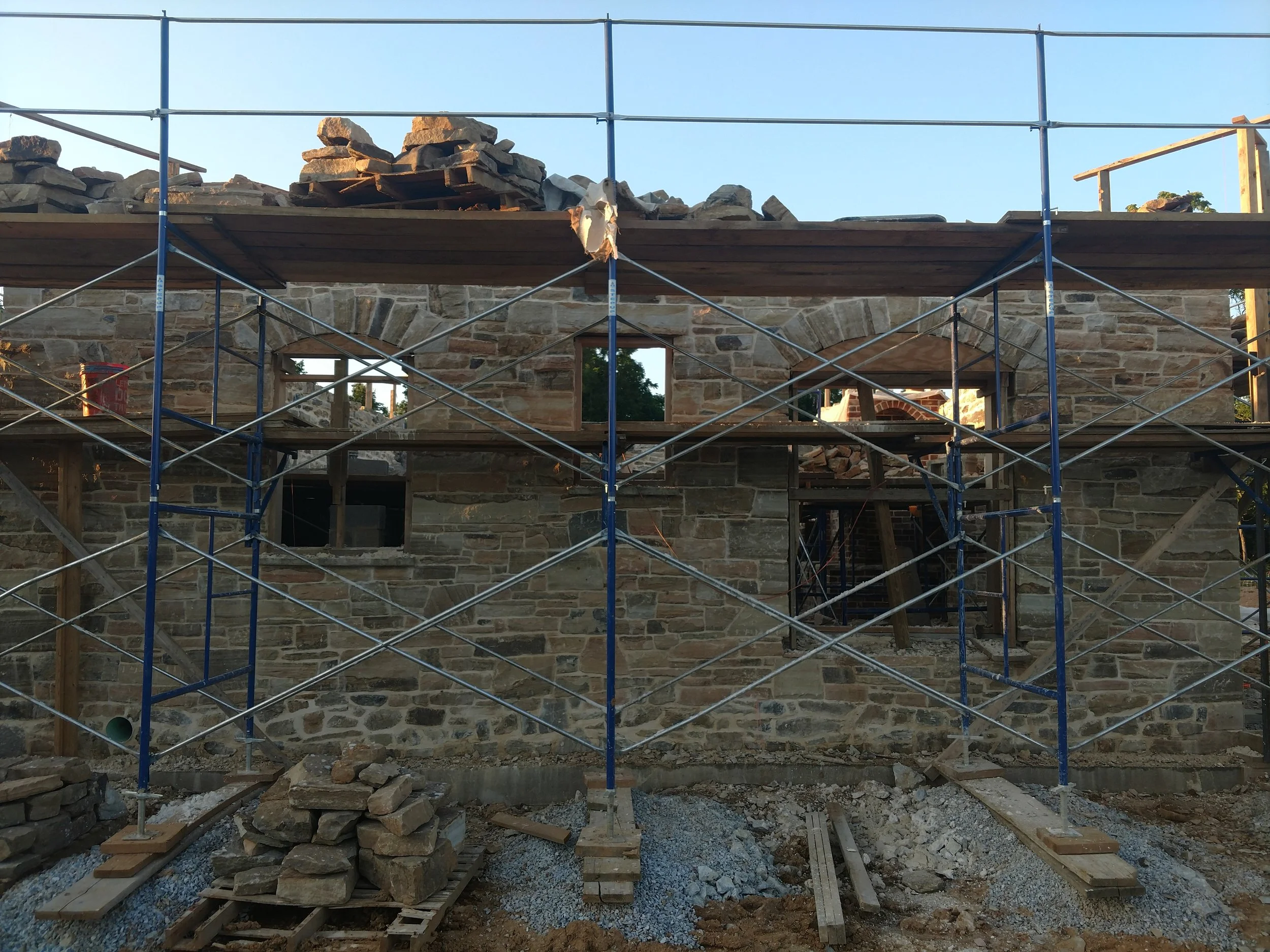 The wooden forms or "falsework", seen in the windows, are arches which serve only to aid the construction and will be removed once the mortar has cured and the arches can support themselves.