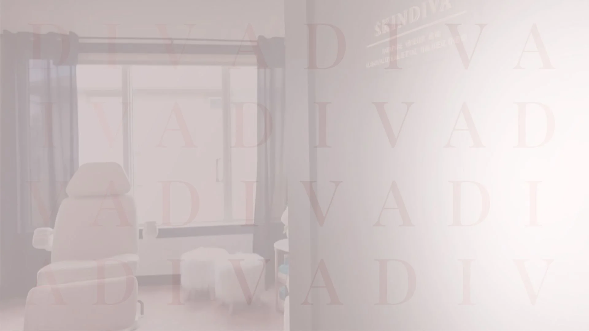 SkinDiva's injection room with an adjustable bed near a window, with a chair and window curtains.