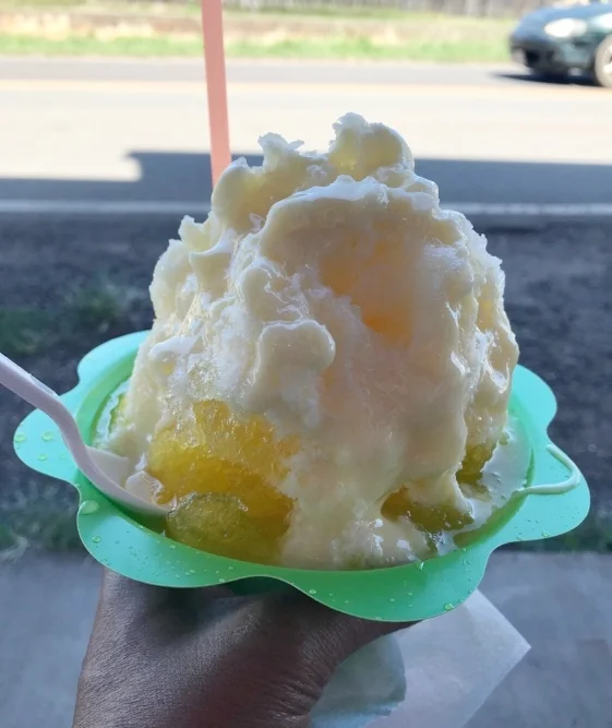 Shaved ice from Malia’s…a scoop of vanilla swirl ice cream with shaved ice covered in mango syrup and cream.