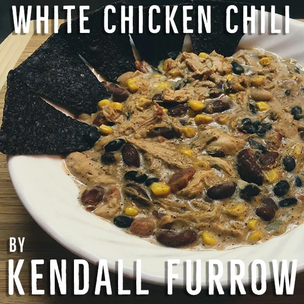 “Imagine a brisk autumn morning tailgate; Frosty grass, visible breath and toboggan hats all around. Now imagine holding a steamy bowl of warm, spicy white chicken chili served with fresh tortilla chips in lieu of that old kitchen spoon. A bowl of this spicy goodness will make stomachs happy, full and warm all around just in time for the first kickoff of the day.”
