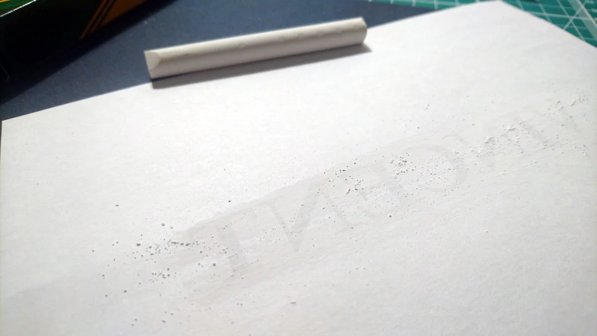 Chalk applied to the back of paper in order to trace lettering onto dark card stock