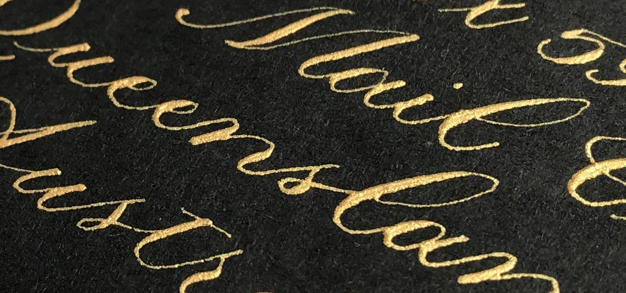 Close up of Dr Ph Martin's Copper Plate Gold Iridescent Ink on black A6 envelope