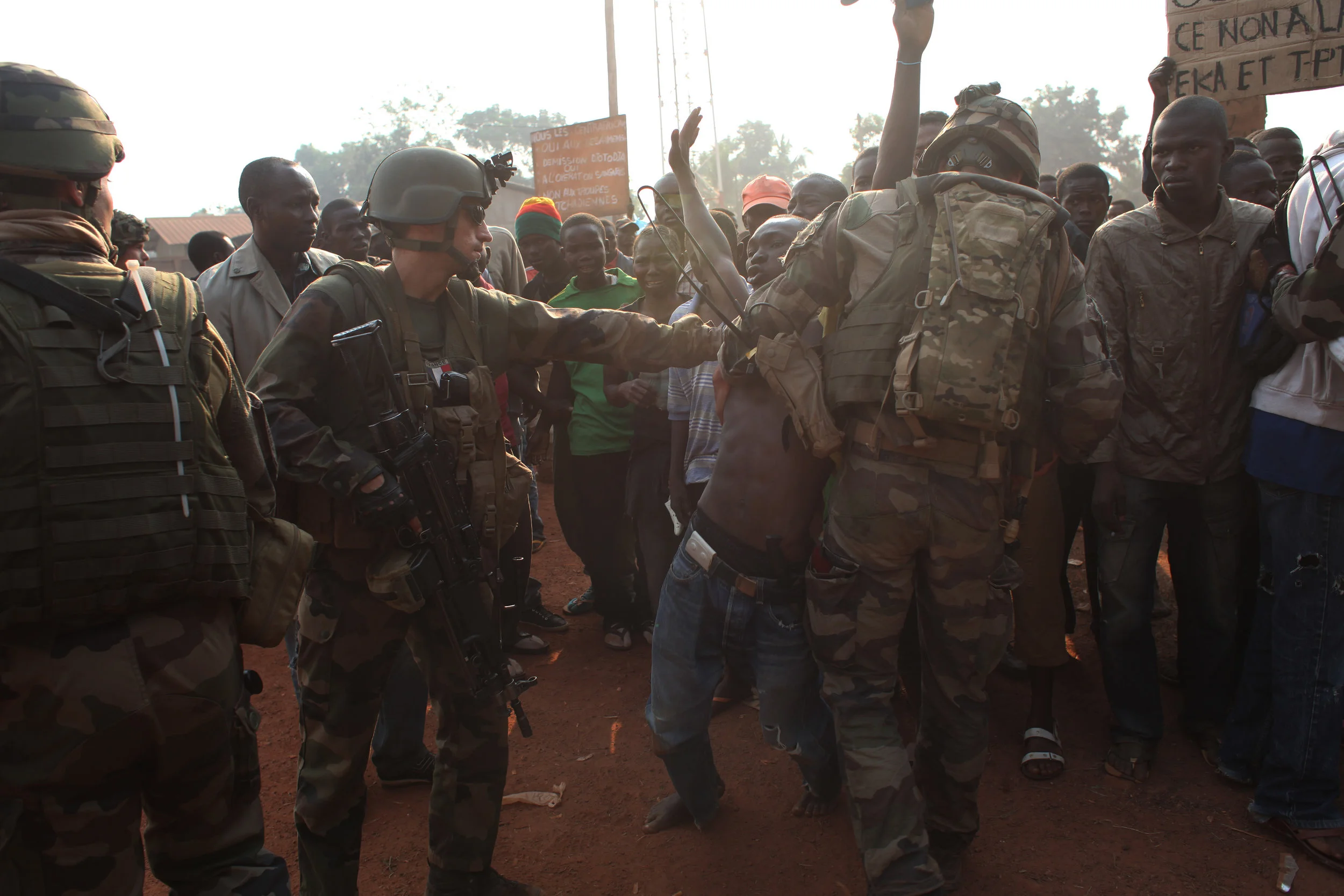 French soldiers try to calm a protester minutes after Chadian soldiers shot into the crowd by the airport in Bangui, in December 2013.