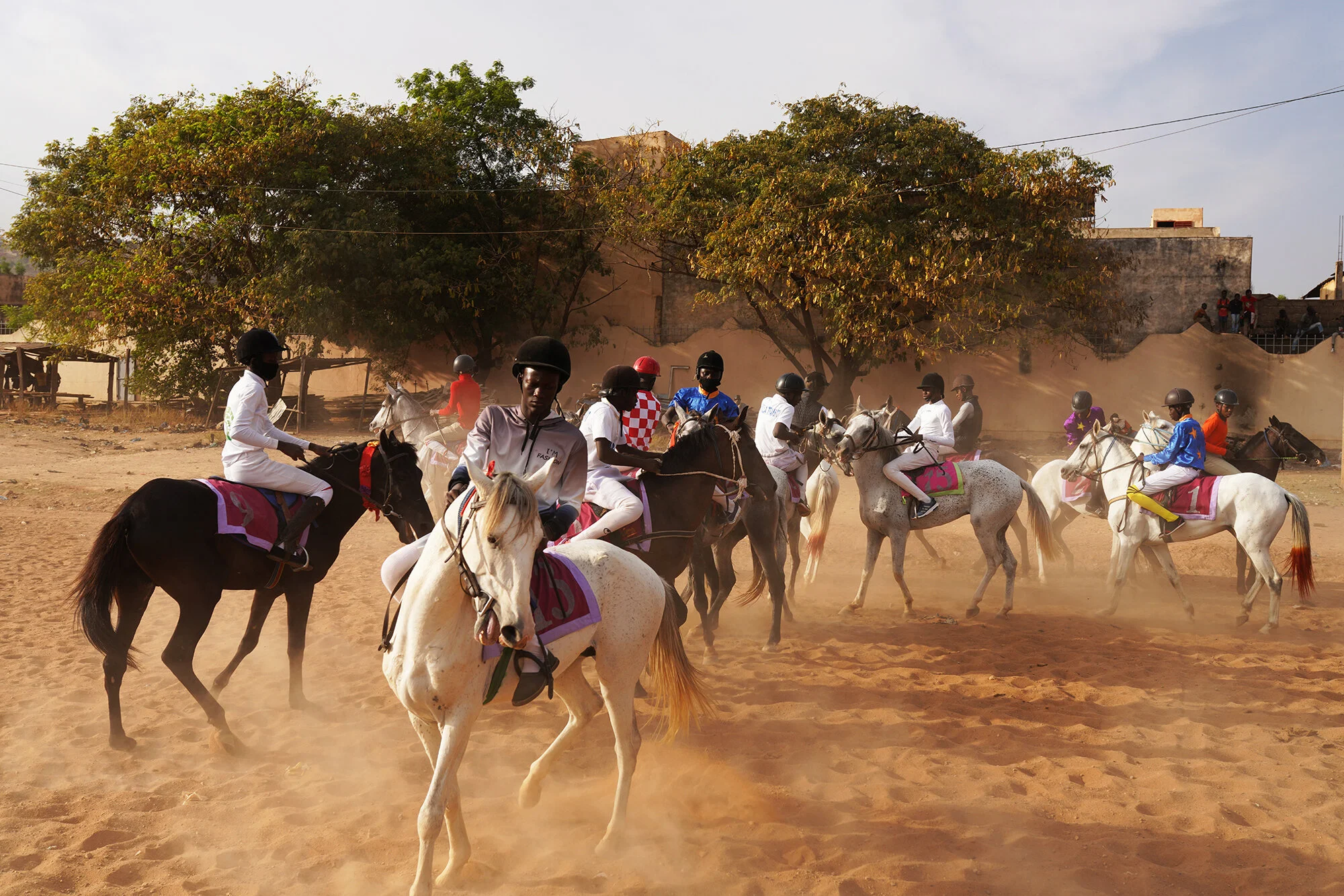  Jockeys are preparing to ride during a race without spectators during the state of emergency in Bamako, Mali, in December 2020. 