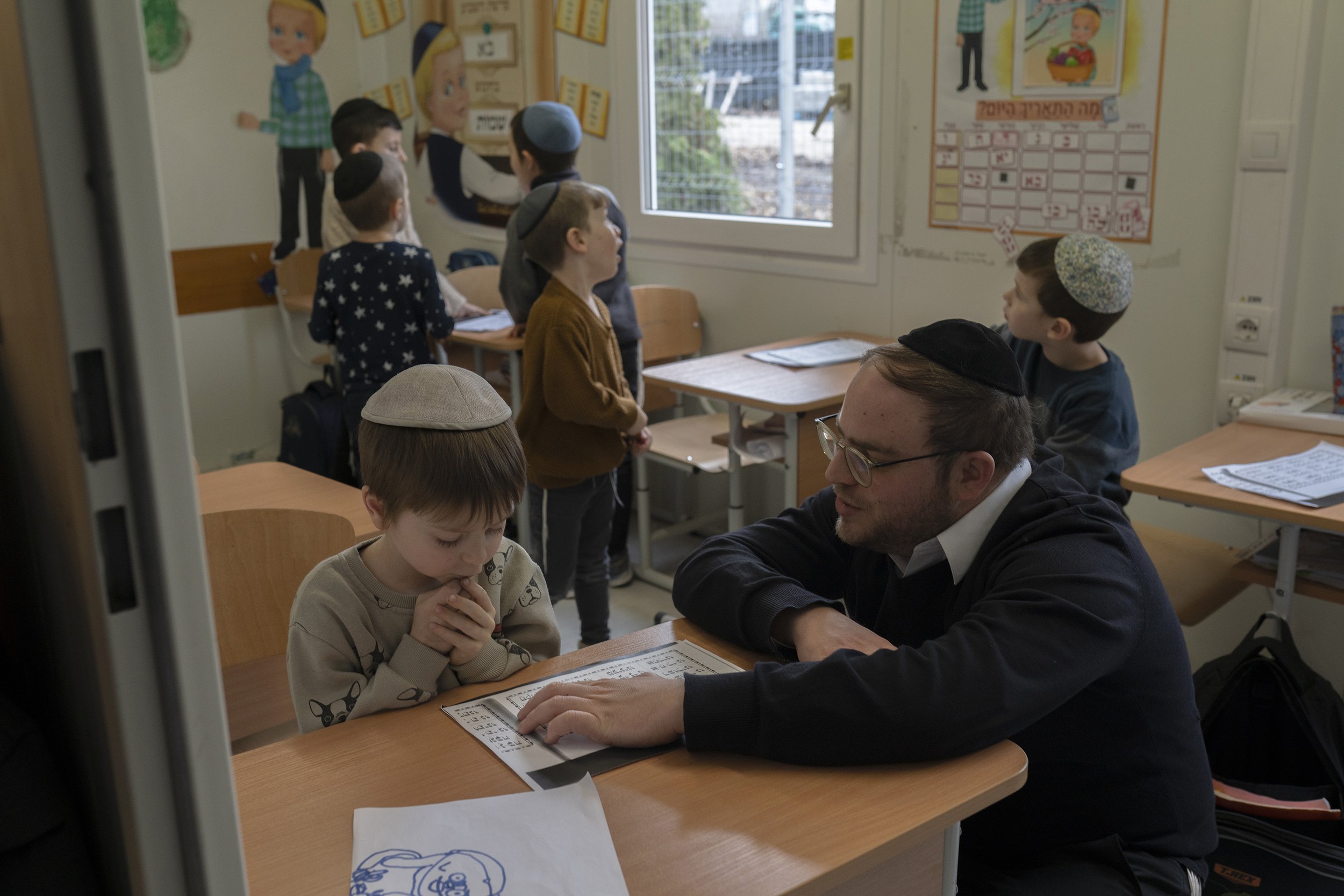  Refugees take part in a Hebrew class at a school set up near the hotel.&nbsp; 