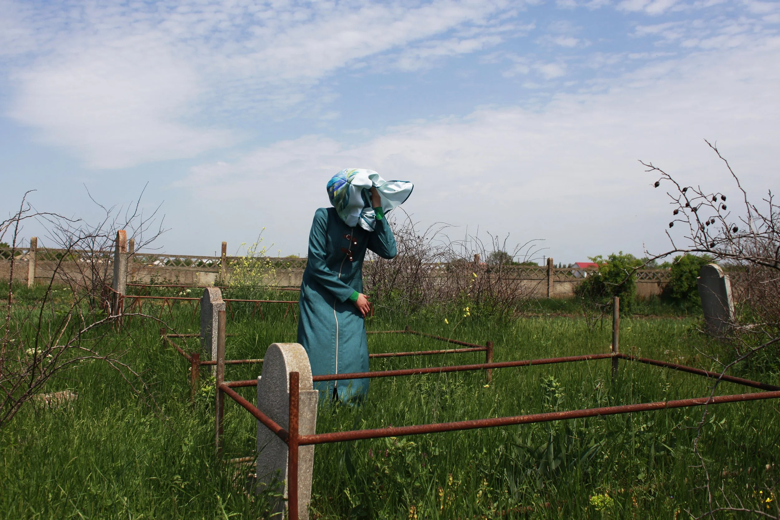  A girl from the Tatar community visits a graveyard in a village outside Constanta, Romania, in 2018. 