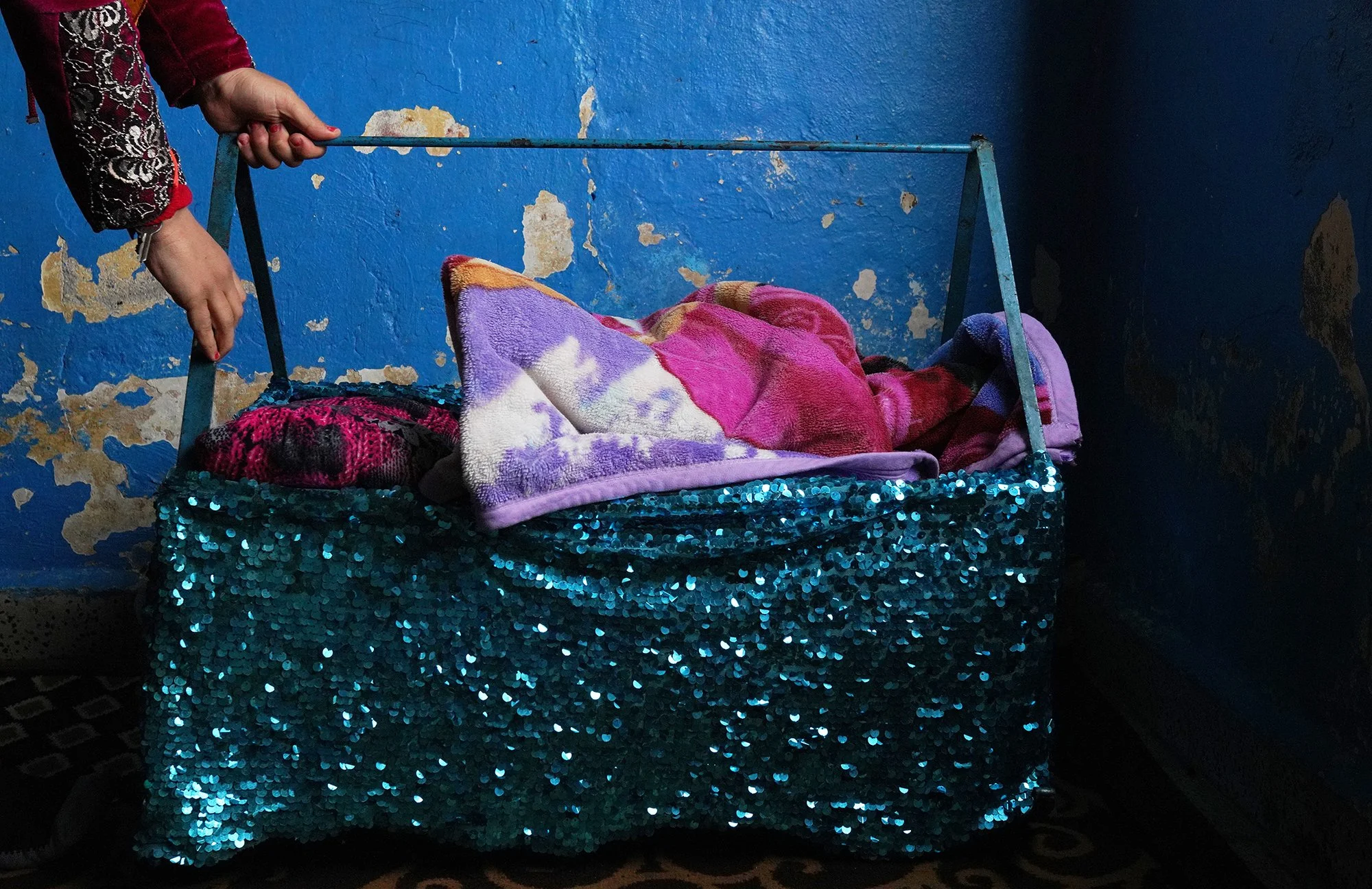  A Syrian refugee hold a baby bed in Tripoli, Lebanon.  