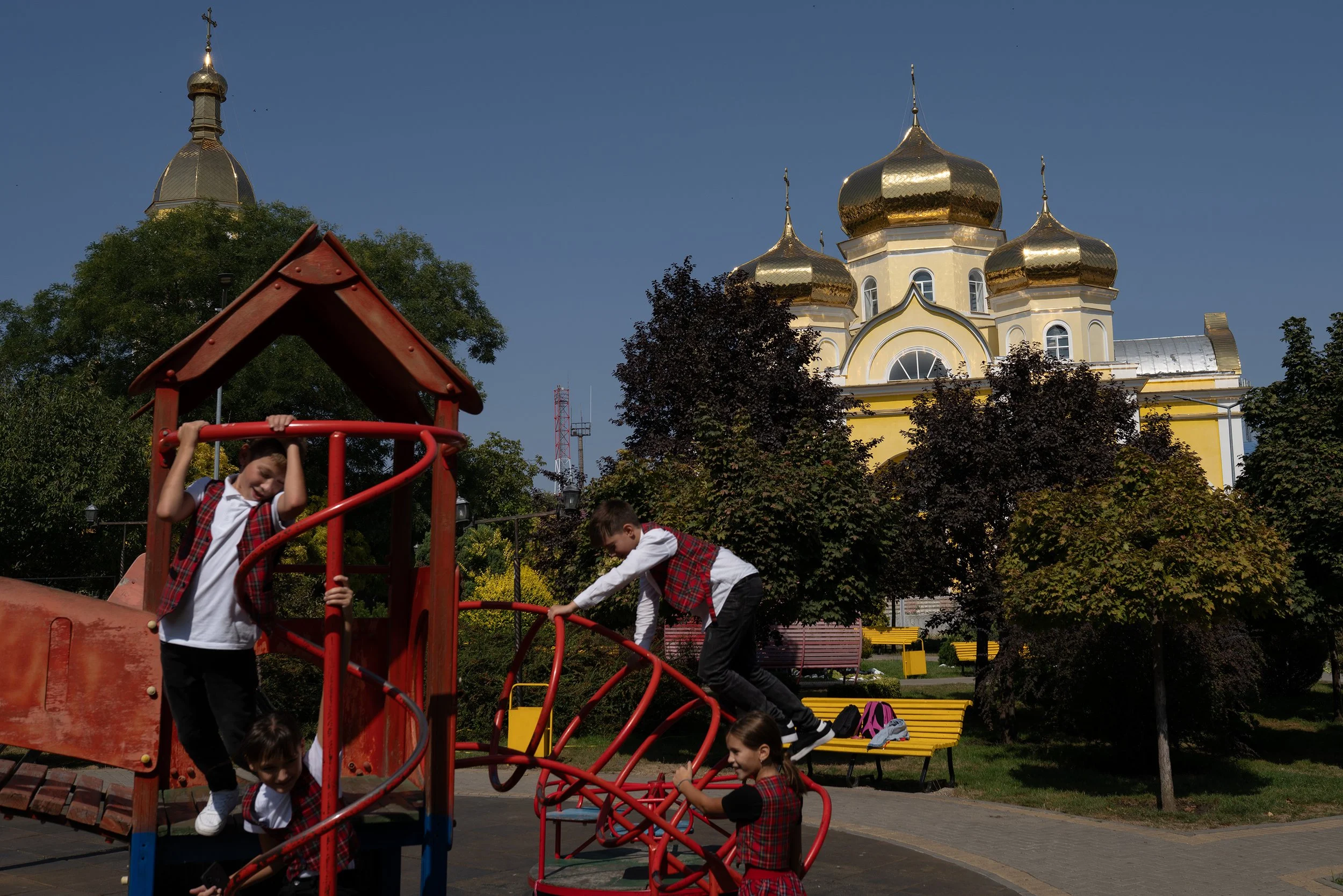  Children play in the park by the church in the center of Comrat, Moldova, in 2023.  