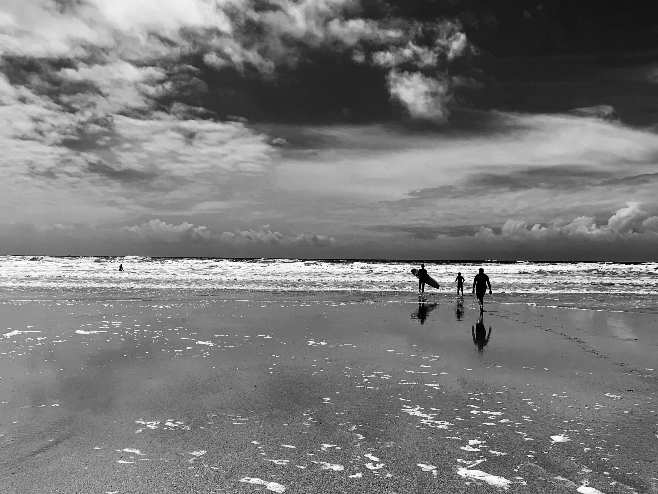 Reflection of Surfers on Beach