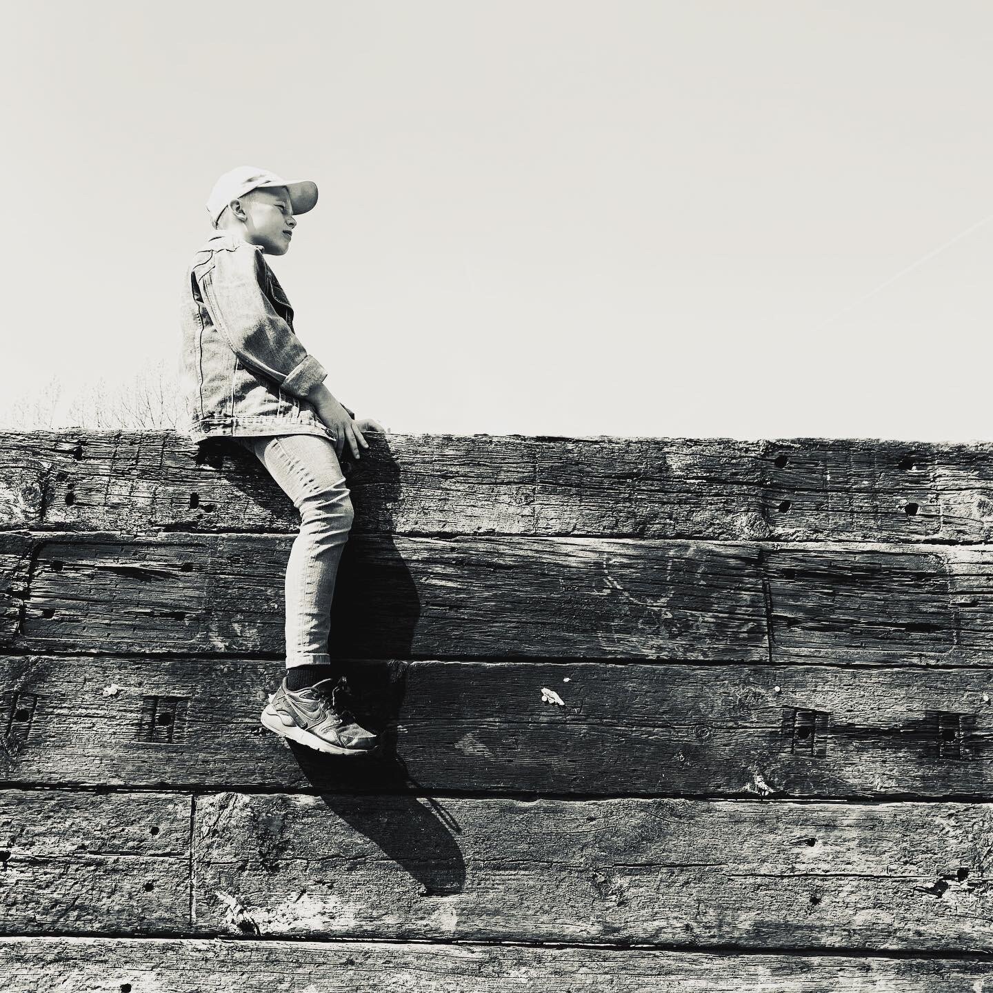 Boy Sitting on Wall of Sleepers
