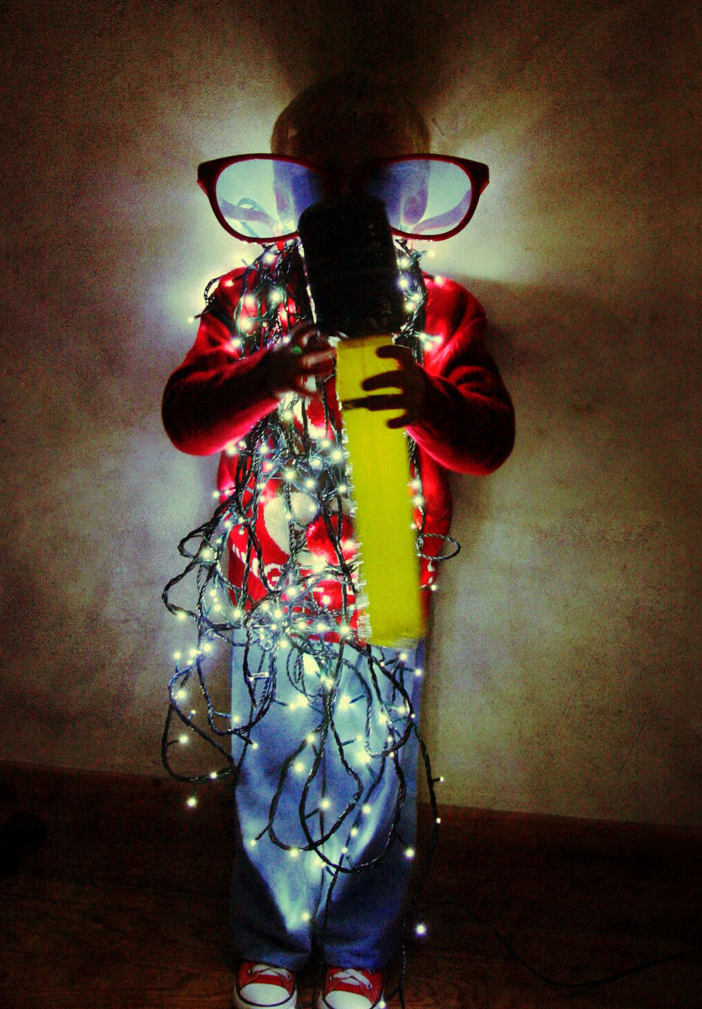 Boy Wrapped in Christmas Lights