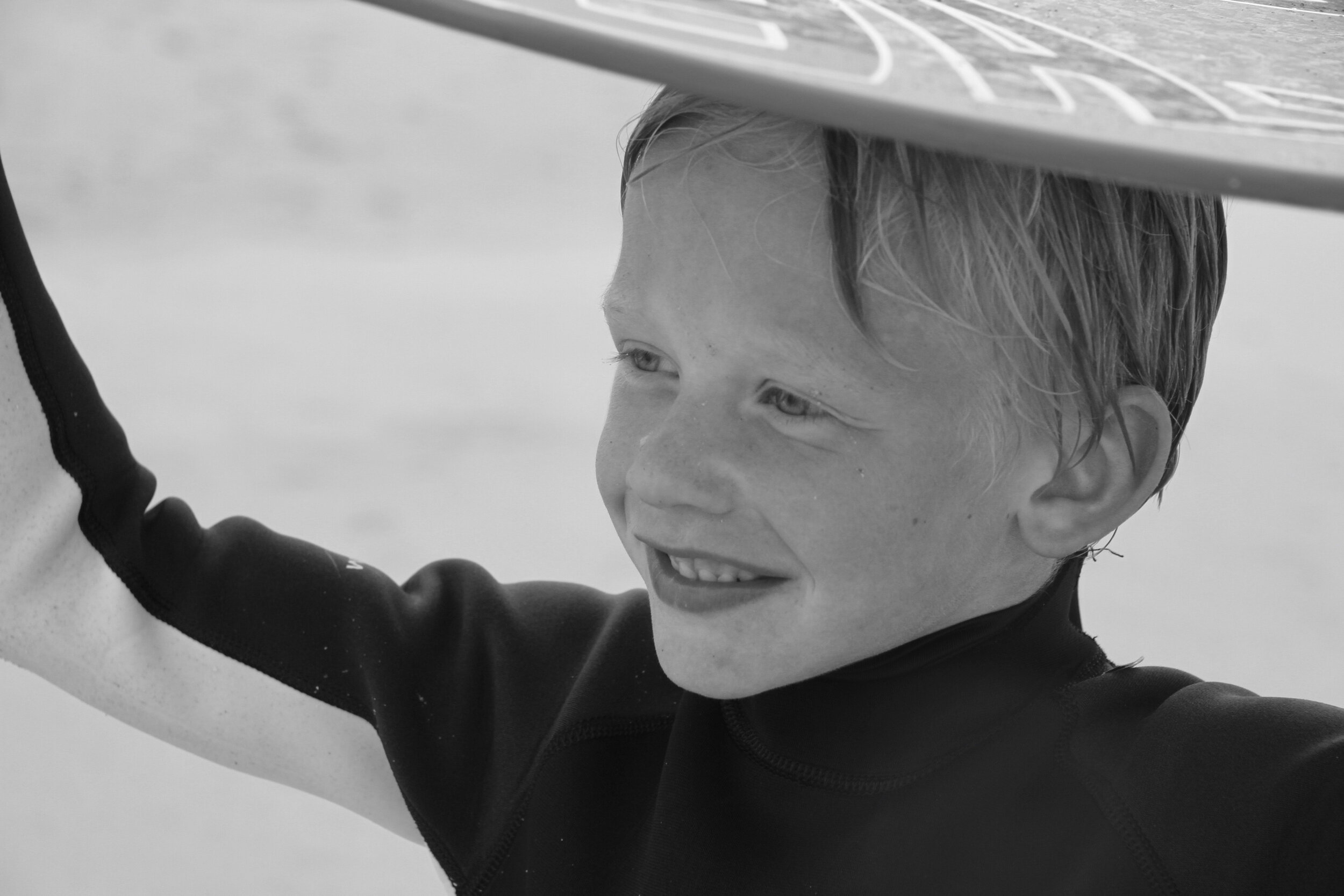 Boy Skim Boarding on Beach