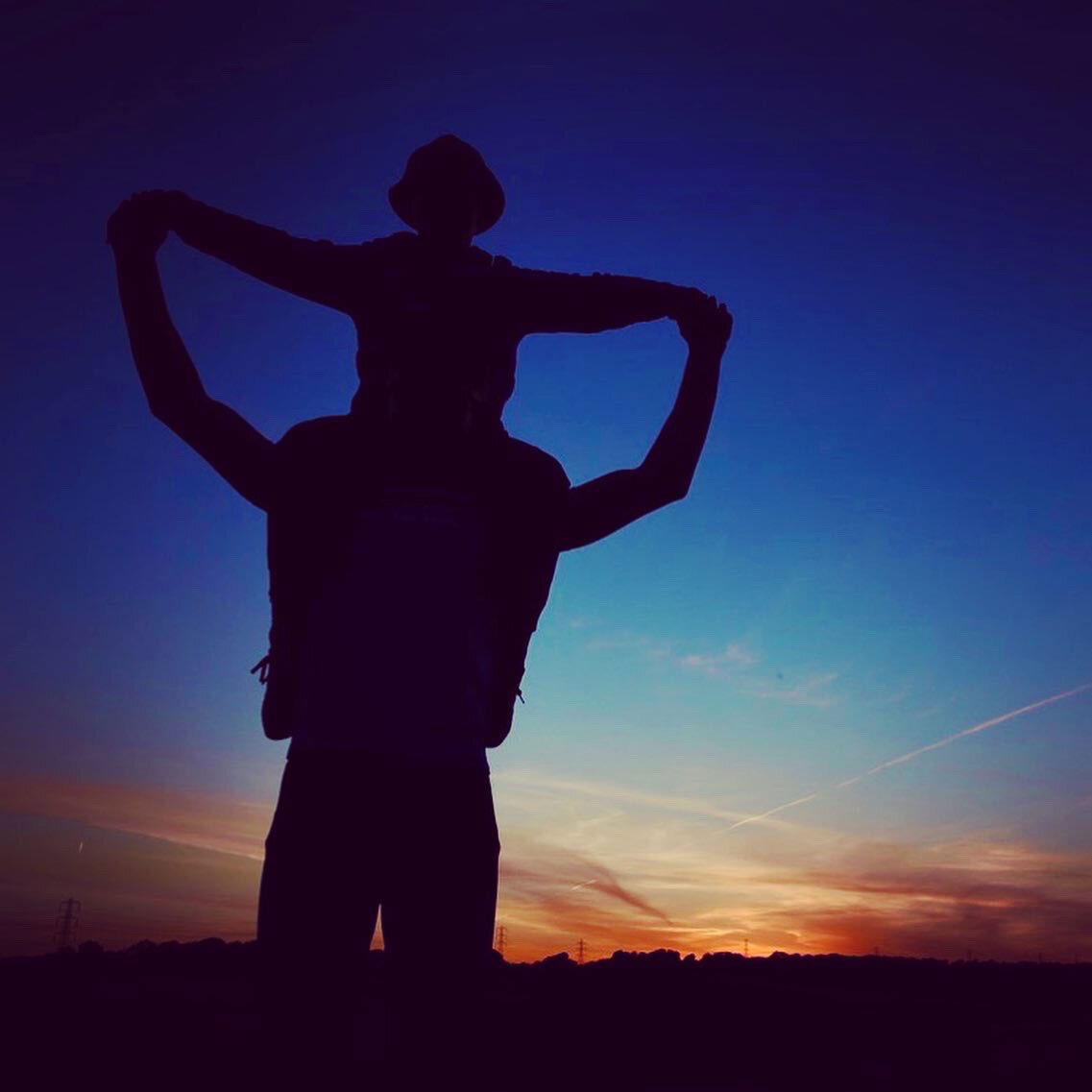 Silhouette of Brother Giving Shoulder Ride to Brother