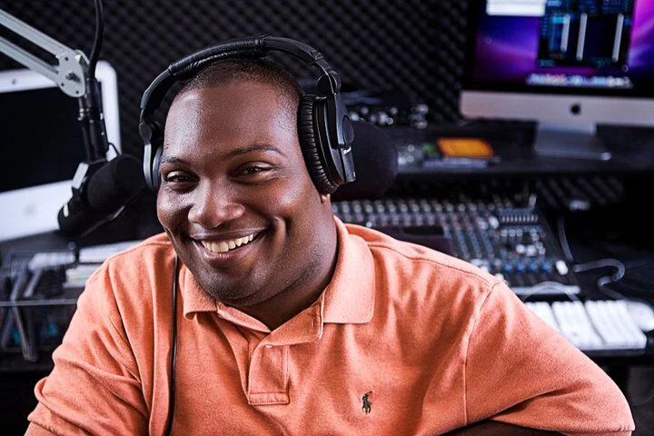 Alex Jackson at Radio Station at College of Charleston with headphones
