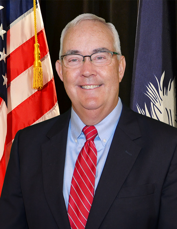 William Floyd, a white man with glasses in a suit.