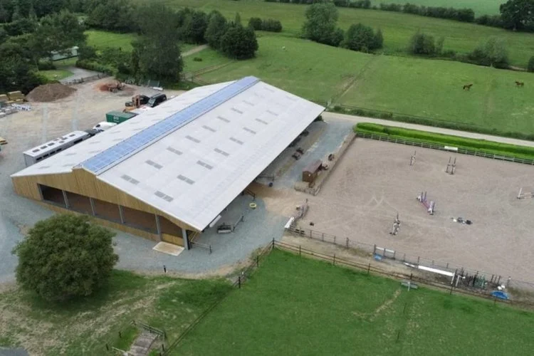 Aerial view of an equestrian arena and stable building designed by AC Jackson