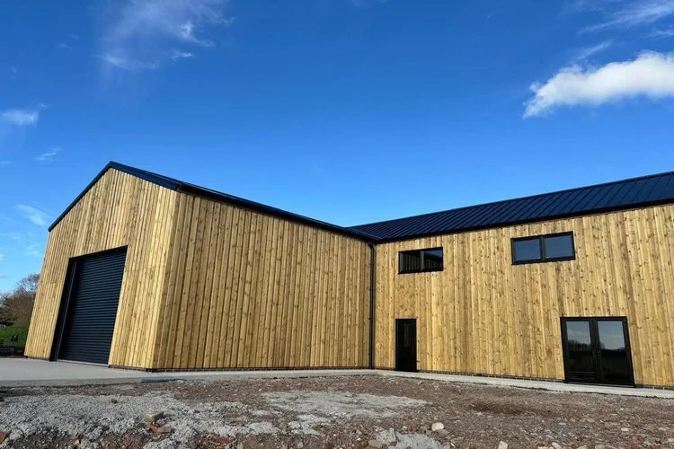 Timber clad commercial building with black roof