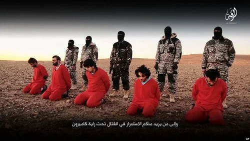 This undated image, taken from video posted online Jan. 3, 2016, by the communications arm of the Islamic State group, purports to show IS militants executing five men whom they accuse of having spied for Britain in Syria.