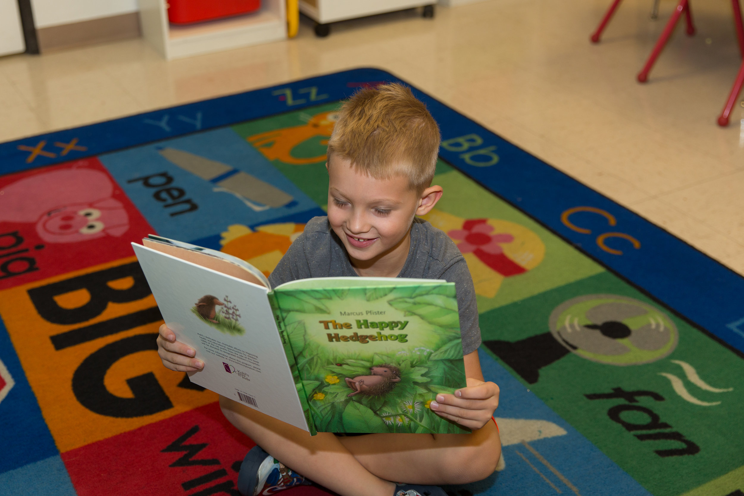 ChildReadingOnCarpet.JPG