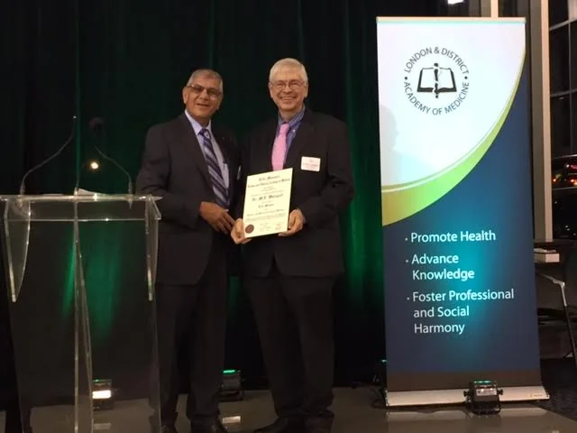 Dr. Mohamed Mithoowani presents Dr. Michael Weingert (right) with his Life Member Award at the 87th Annual General Meeting.