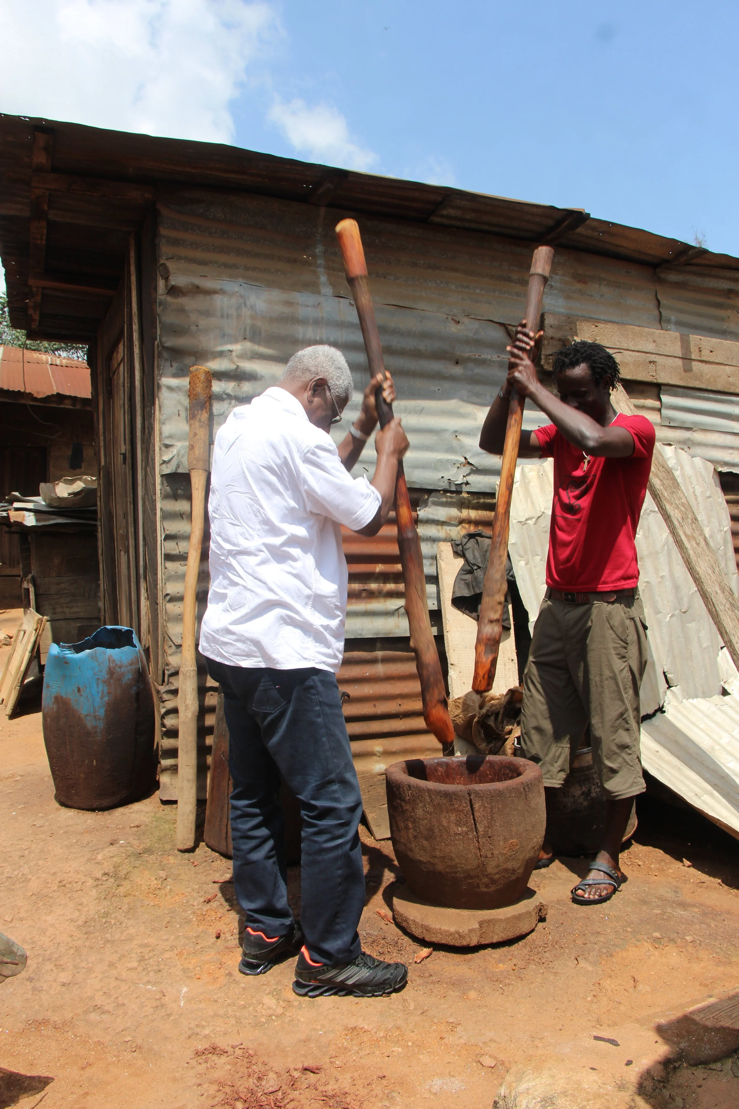 Pounding Adinkra dye with Peter Boakye of Adinkra Home Workshop Ntonso, Ghana