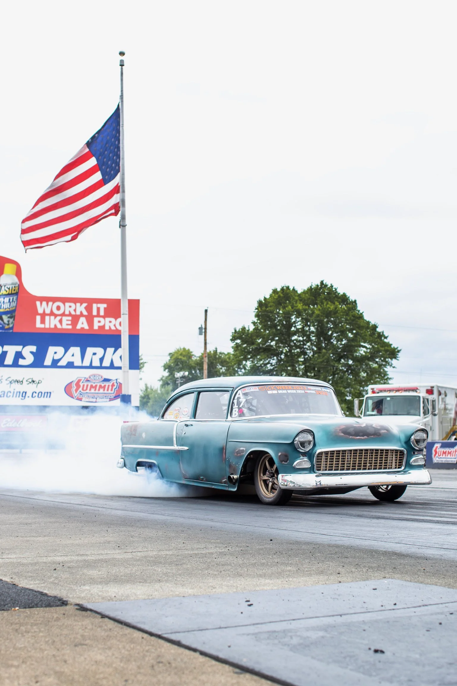 55 doing a burnout with American flag in the back