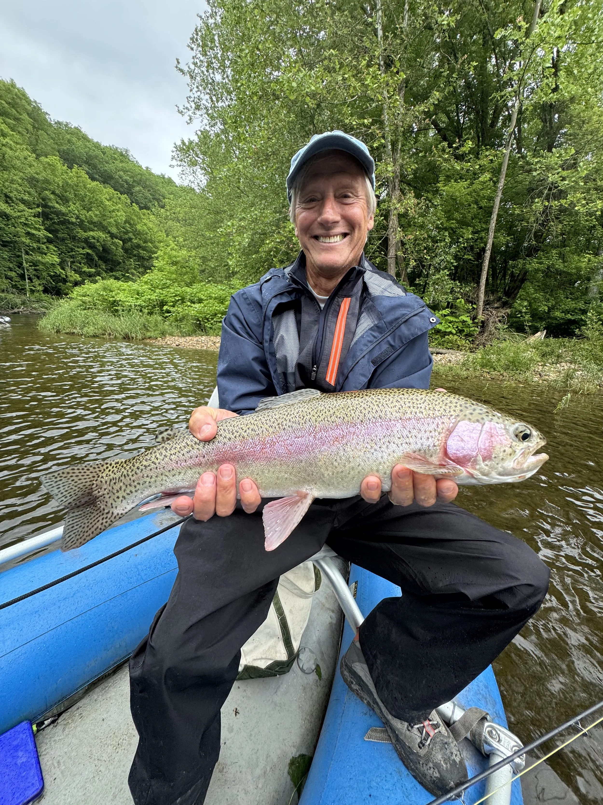 smiling man with large rainbow float.jpeg