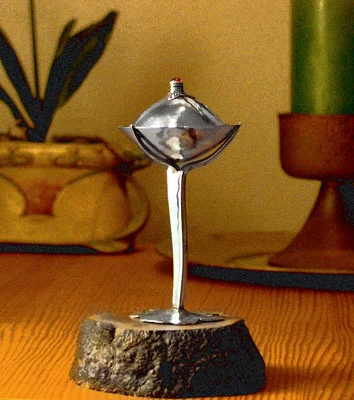 Silver w/Garnet cabochon, 5.5x2.5 in. on Briar root stand.