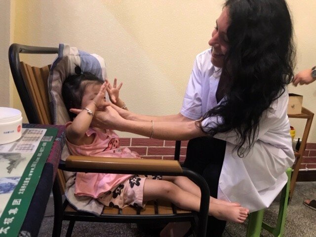 Jenna helping a child