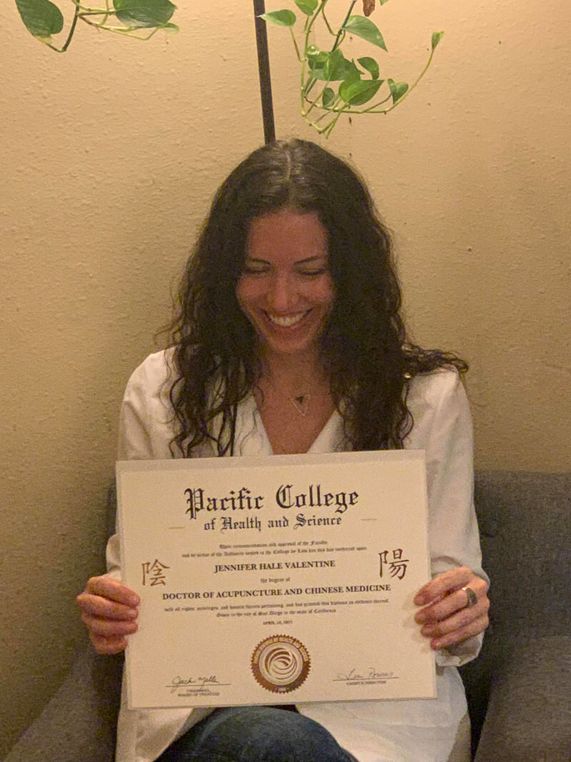 Jenna Valentine, happily receives her Doctorate diploma
