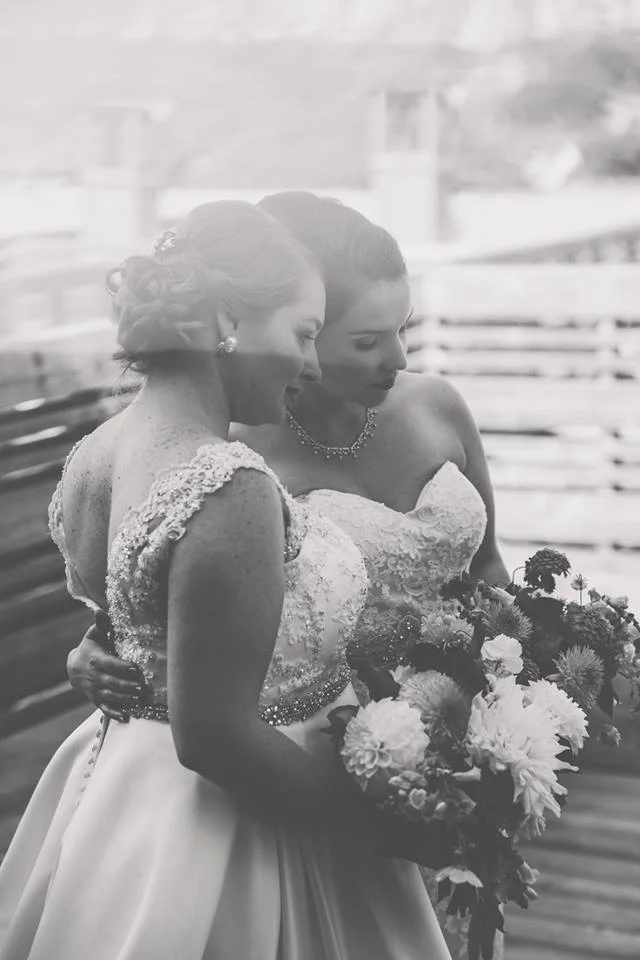 The gorgeous couple Taylor and Sarah on their wedding day. Photo courtesy of Rebecca Lozer Photography. Bridal makeup by Maya Goldenberg.