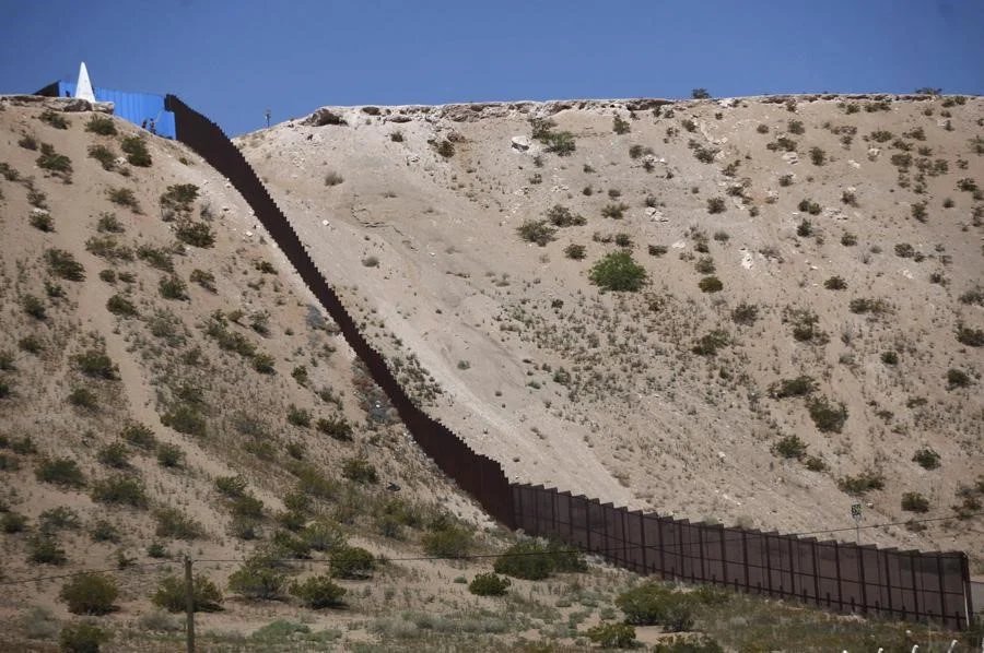 Part of the border-fence is blue after artist Ana Teresa Fernández and members of Border/Arte painted it, to give it the illusion of transparency during Borrando la Frontera, or Erasing the Border, art project on April 9, 2016. Jose Luis Gonzalez / Reuters