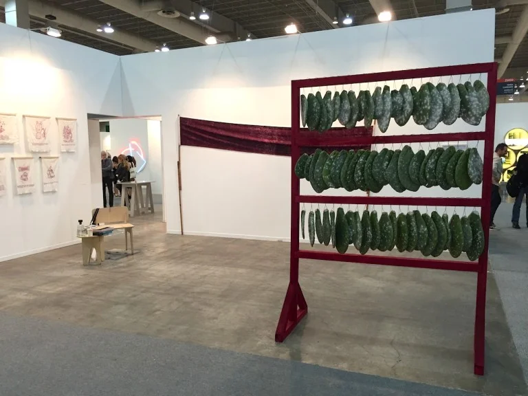Another artist from Mexico City, Tania Candiani also explored color and commerce in her installation for Brazilian gallery Vermelho . Her works were made with cochineal, the tiny insect used to produce a red pigment that became a highly desirable commodity in Europe after the Spanish conquest of Mexico. Her sculpture, made from cactus paddles, were covered in the small creatures that colored the wooden frame. A deep crimson hand-dyed banner leaned against the wall as a kind of protest flag, recalling the pigment’s violent and tumultuous colonial history.