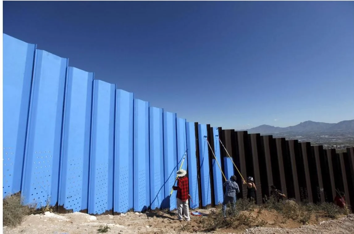 Artist Ana Teresa Fernández and others paint the border-fence in Ciudad Juarez, Mexico, on April 9, 2016. Jose Luis Gonzalez / Reuters