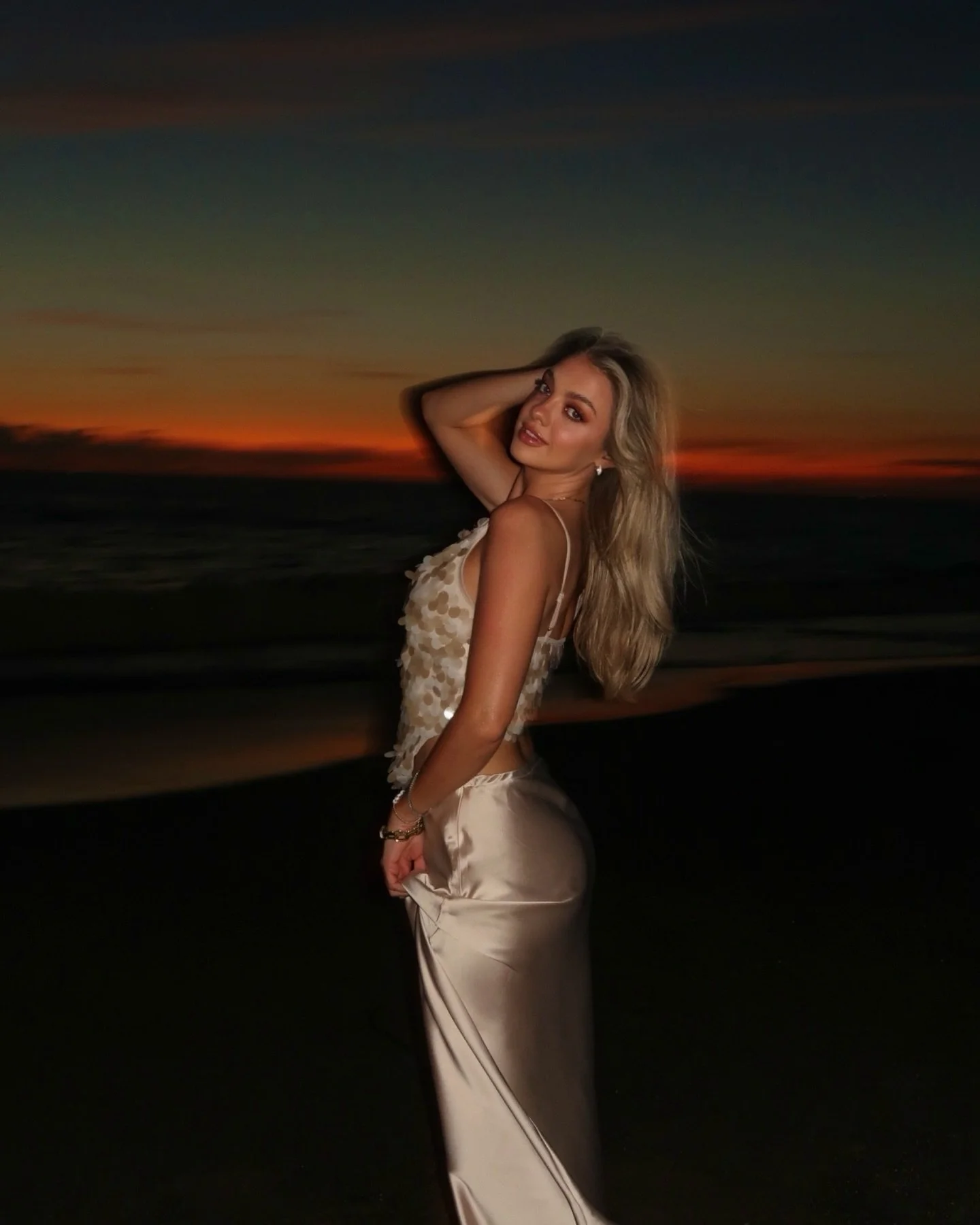 Proof that the best moments happen after the sun goes down 🧡✨🥂🌴🌊🌅 @modelistemagazine @velasvallarta 
.
.
.
sunset beach dinner, girls trip memories, beach night outfits, satin slip skirt outfit, beach dinner aesthetic, sunset by the ocean, girls