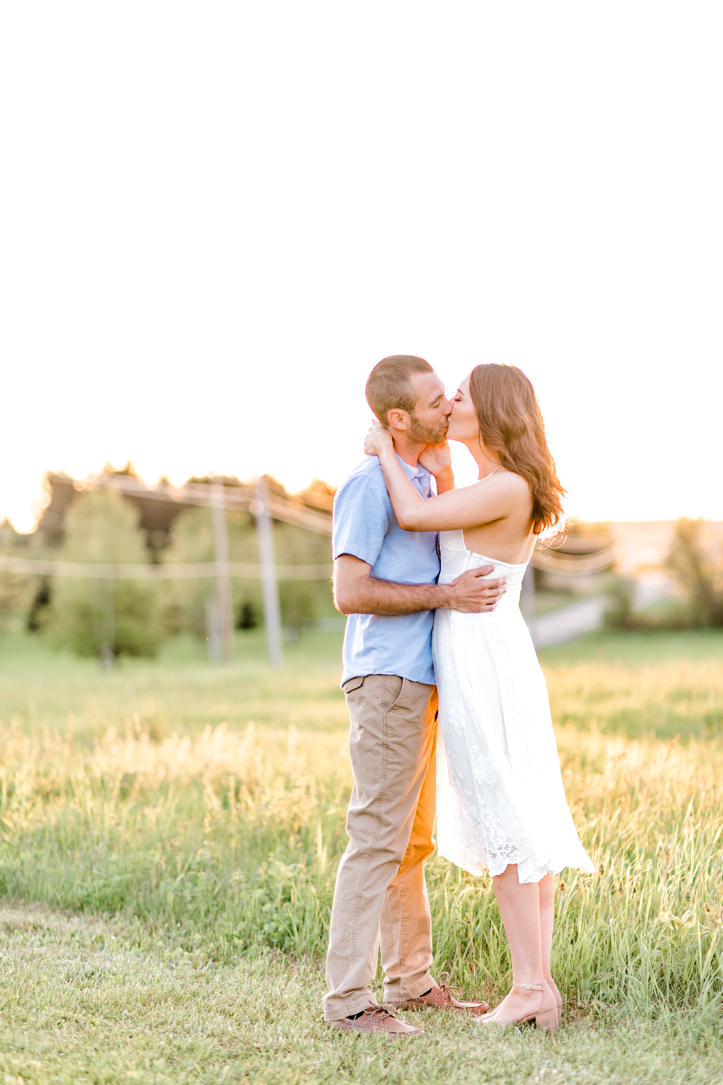 Engagement pictures should be romantic and fun! This golden glow session was jus that. Sunrise orchard engagement photo ideas with flower blossoms. Engagement outfit ideas.