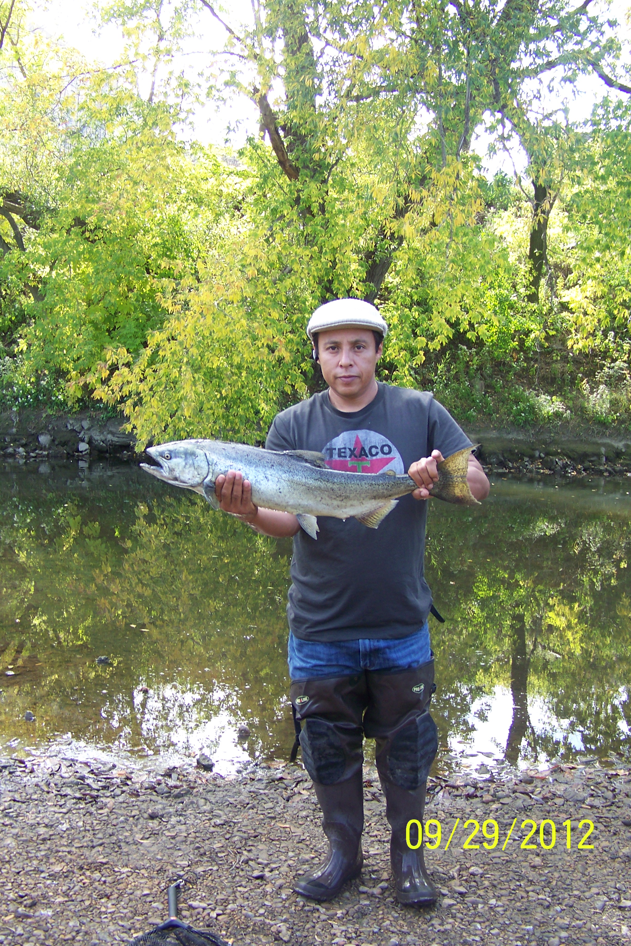  Young person holding up a fish from the Menomonee River 