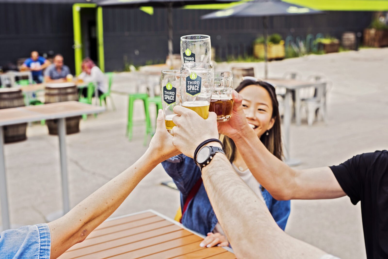  Patrons cheersing their beers at Third Space Brewing Company 