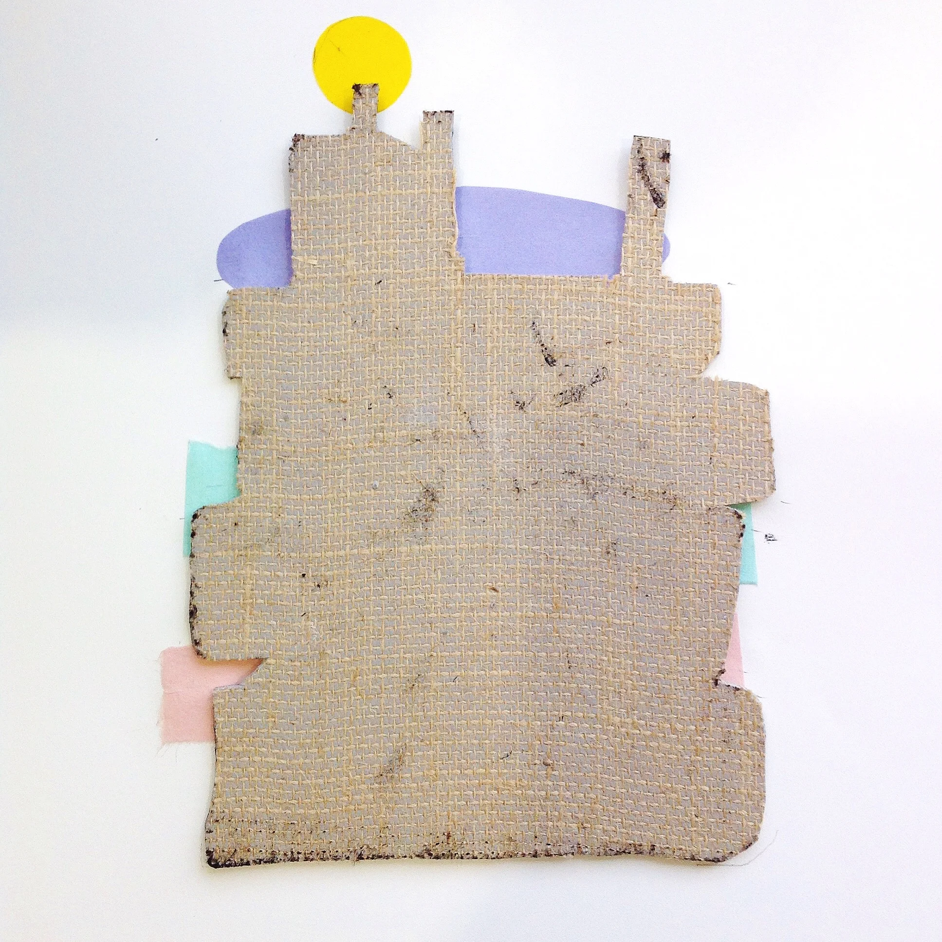 Place the Lino block face down over the paper prepared with coloured shapes.
