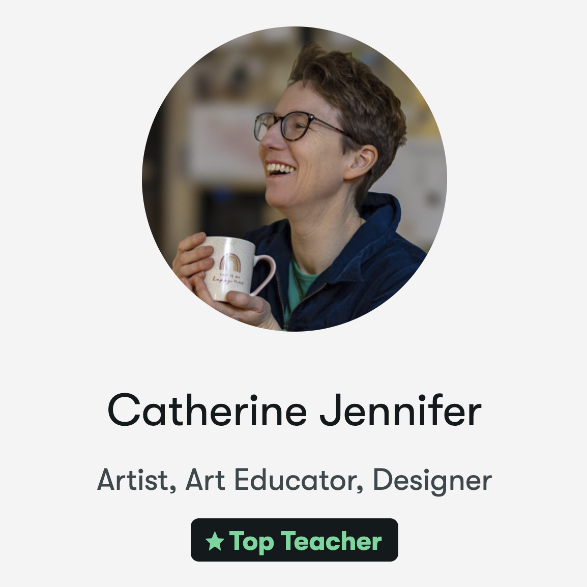 Catherine Jennifer, Skillshare Top Teacher, smiling and holding a coffee mug