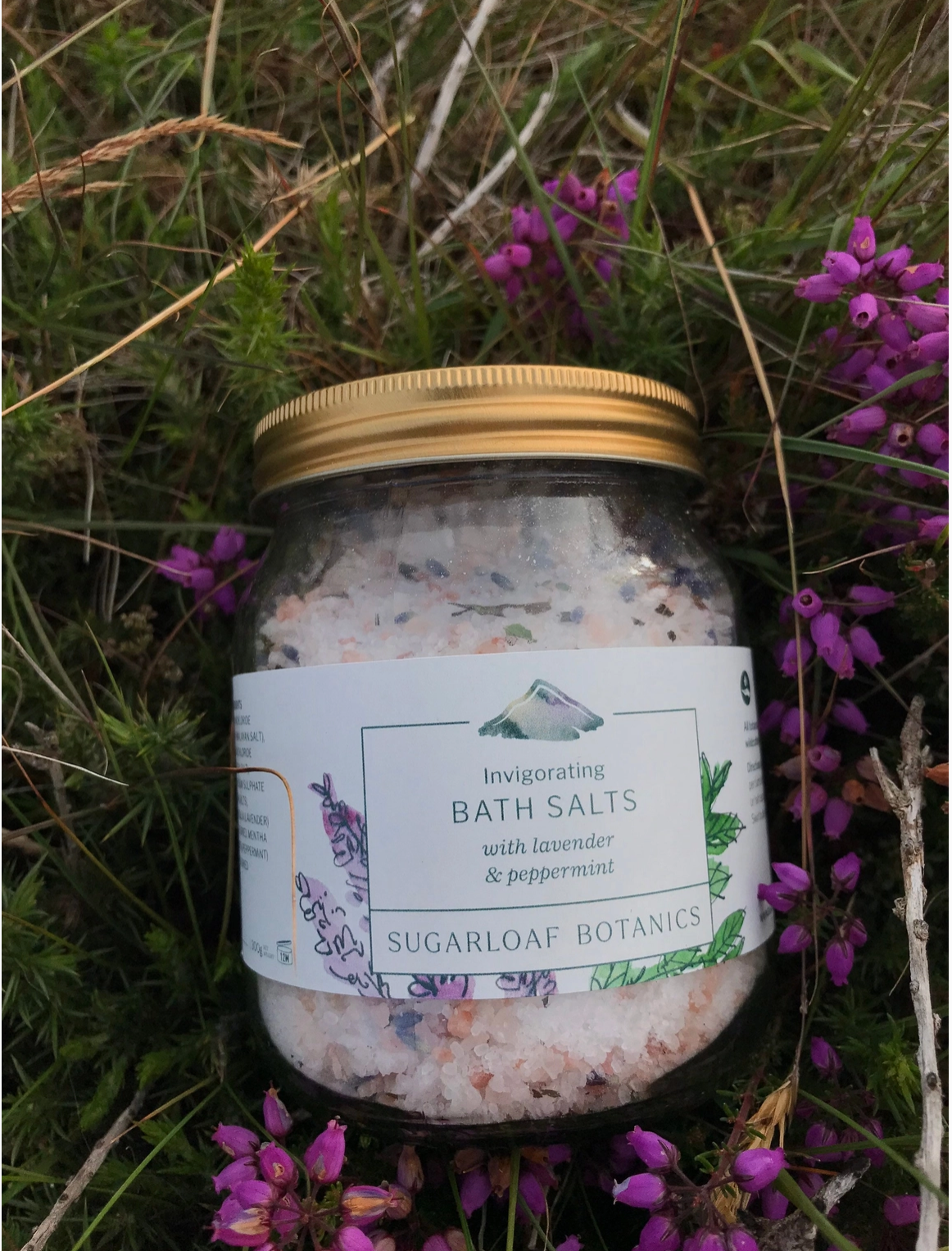 Invigorating bath salts in a glass jar with metal lid.made with Epsom salts, pink Himalayan salt and lavender and peppermint grown on site in Wicklow Ireland. Moon Family Concept Store Ireland