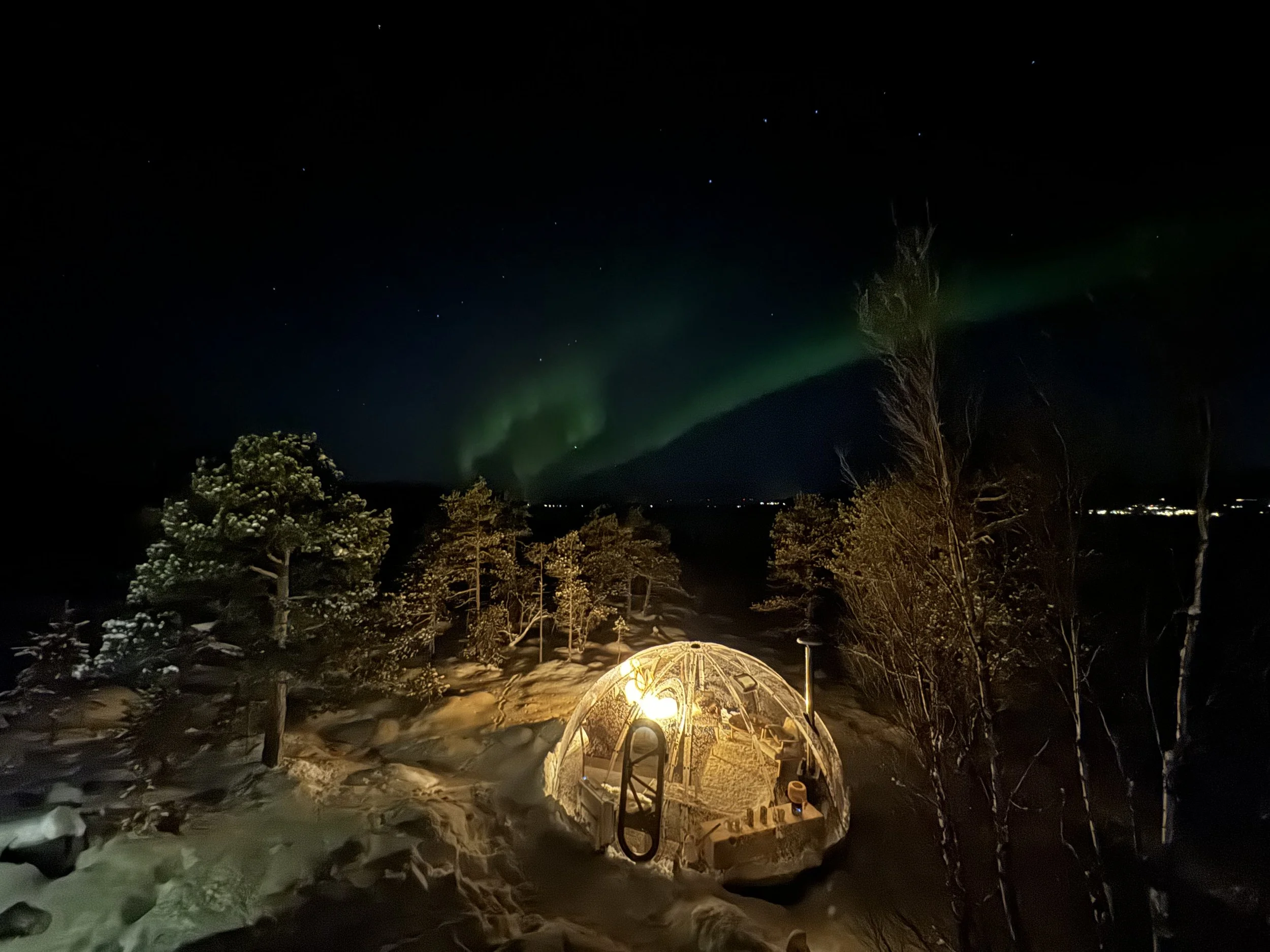 Northern Lights above ACIN's Aurora glass igloo overlooking Malangen Fjord near Tromsø